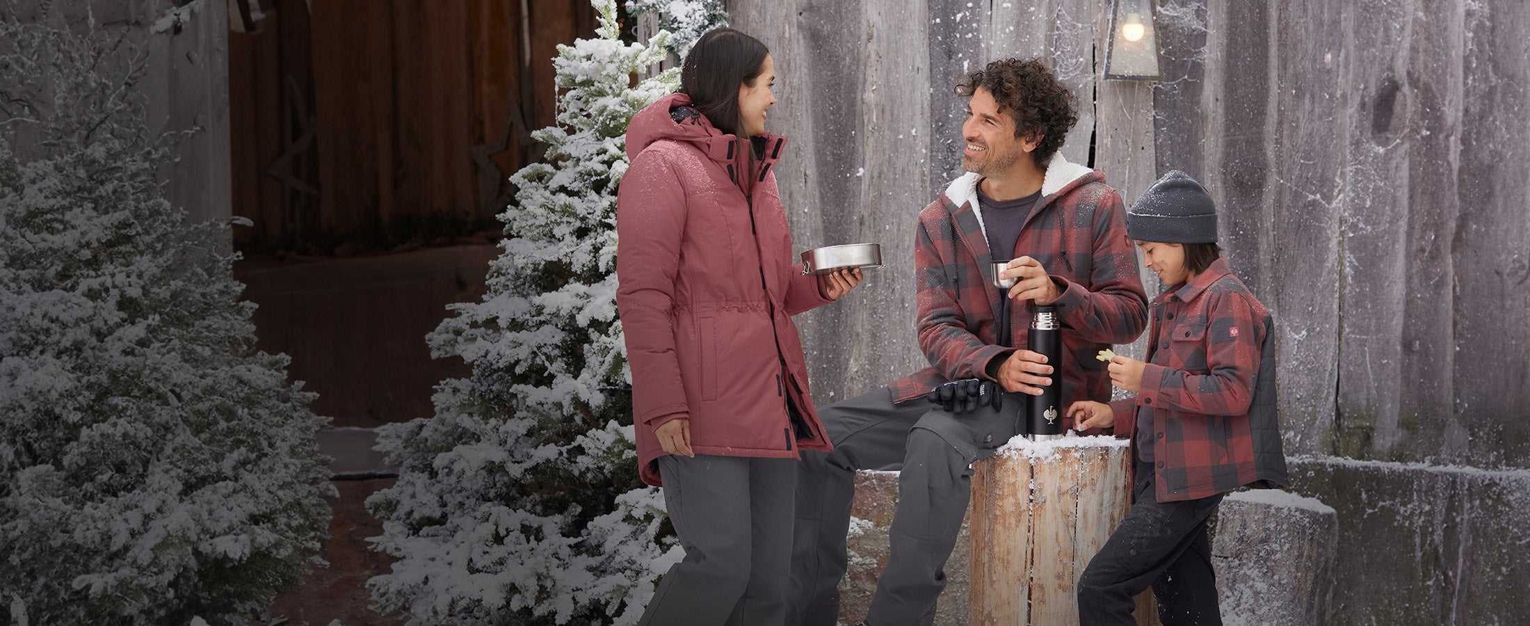 Woman, man, and boy wearing clothing from the e.s.iconic collection in a winter setting